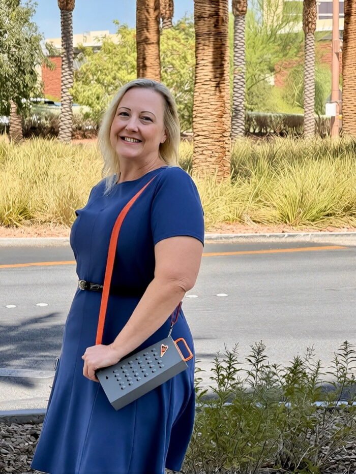 female fan wearing grater purse palm trees